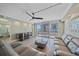 Living room with sliding glass doors to balcony, and modern furnishings at 1212 Benjamin Franklin Dr # 306, Sarasota, FL 34236