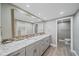 Bathroom features double sinks, granite countertops, and updated cabinets for storage at 1212 Benjamin Franklin Dr # 306, Sarasota, FL 34236