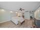 Spacious main bedroom features a ceiling fan, vinyl plank flooring and ensuite bathroom at 1212 Benjamin Franklin Dr # 306, Sarasota, FL 34236