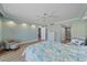 Spacious bedroom with wood-look floors, light walls, and a ceiling fan at 1212 Benjamin Franklin Dr # 306, Sarasota, FL 34236
