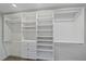 This walk-in closet features custom shelving and storage options at 1212 Benjamin Franklin Dr # 306, Sarasota, FL 34236