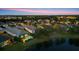 Beautiful twilight aerial view of homes in a well-planned community around a serene lake and lush greenery at 12237 Longview Lake Cir, Bradenton, FL 34211