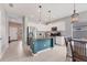 Well-lit kitchen featuring white cabinetry, granite countertops, and stainless steel appliances with dining area at 12237 Longview Lake Cir, Bradenton, FL 34211