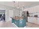 Kitchen island featuring granite countertops, a double sink, and modern pendant lighting at 12237 Longview Lake Cir, Bradenton, FL 34211