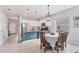 Bright kitchen and dining area featuring white cabinets and modern appliances adjacent to a dining space at 12237 Longview Lake Cir, Bradenton, FL 34211