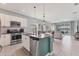 Modern kitchen with stainless steel appliances and island that opens to a spacious living area at 12237 Longview Lake Cir, Bradenton, FL 34211