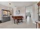 Elegant living room with piano, stylish chandelier, and seamless transition to other living spaces at 12237 Longview Lake Cir, Bradenton, FL 34211