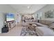 Open-concept living room with seamless access to kitchen and outdoor living spaces at 12237 Longview Lake Cir, Bradenton, FL 34211