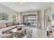 Comfortable living area with natural light, tile flooring, and an opening leading to a pool view at 12237 Longview Lake Cir, Bradenton, FL 34211