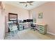 Home office with pink walls, custom corner desk, computer and a rocking chair at 12237 Longview Lake Cir, Bradenton, FL 34211