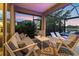 Inviting screened patio with comfortable seating overlooking a pool and tranquil lake view at 12237 Longview Lake Cir, Bradenton, FL 34211