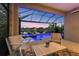 Relaxing screened-in patio featuring comfortable seating and views of a pool, spa, and lake at 12237 Longview Lake Cir, Bradenton, FL 34211