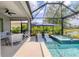 Exterior pool area with covered seating, screened-in pool and lake view at 12237 Longview Lake Cir, Bradenton, FL 34211