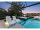 Relaxing outdoor pool with a spa and two chairs for lounging with a great view of the water at 12237 Longview Lake Cir, Bradenton, FL 34211