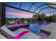 Beautiful pool and spa with lighting, offering relaxation and stunning views of the lake at 12237 Longview Lake Cir, Bradenton, FL 34211