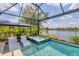 Enclosed Pool with a hot tub, two lounge chairs and view of the lake at 12237 Longview Lake Cir, Bradenton, FL 34211
