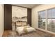 This bedroom features a mountain mural, bedside tables, and a large window overlooking a garden at 12535 Estrella Blvd, Punta Gorda, FL 33955