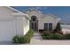 Charming single Gathering home boasting a two-car garage, manicured landscaping, and neutral exterior paint at 12535 Estrella Blvd, Punta Gorda, FL 33955