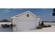 Detached garage with elegant white exterior and landscaping at 12541 Estrella Blvd, Punta Gorda, FL 33955