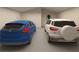 Spacious two car garage with blue Ford Focus and white Ford EcoSport at 12541 Estrella Blvd, Punta Gorda, FL 33955