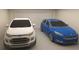 Spacious two-car garage featuring a white Ford EcoSport and a blue Ford Focus at 12541 Estrella Blvd, Punta Gorda, FL 33955