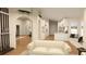 Open-concept living space with bright hardwood floors and white furniture at 12541 Estrella Blvd, Punta Gorda, FL 33955