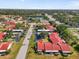 A scenic overview of townhomes, showcasing community amenities like a pond and tennis courts at 1302 58Th W St, Bradenton, FL 34209