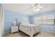 Bright bedroom with neutral walls, floral bedding, and ample natural light at 1302 58Th W St, Bradenton, FL 34209