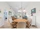 Cozy dining room with a round table, chandelier, and view into the living room at 1302 58Th W St, Bradenton, FL 34209