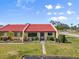 Charming single-story home with a red tile roof, well-maintained lawn, and meticulous landscaping at 1302 58Th W St, Bradenton, FL 34209