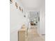 Inviting hallway with light-colored walls, tile flooring, and views into other living spaces at 1302 58Th W St, Bradenton, FL 34209