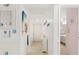 Hallway offering access to the living area and bedrooms, with bright walls and tiled floors at 1302 58Th W St, Bradenton, FL 34209