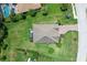 Aerial view of a house with a screened-in patio, surrounded by lush green grass and trees at 15608 31St E St, Parrish, FL 34219