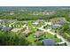 Aerial view of a community with beautiful homes, lush greenery, and tranquil ponds at 15608 31St E St, Parrish, FL 34219