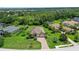 Aerial view of a beautiful home featuring a brick driveway, lush landscaping, and an attached three-car garage at 15608 31St E St, Parrish, FL 34219