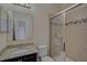 A bathroom with a granite vanity, glass shower, and a view into another room at 15608 31St E St, Parrish, FL 34219