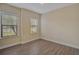 This bedroom offers natural light with hardwood floors and large windows at 15608 31St E St, Parrish, FL 34219