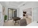 Bright home office with neutral paint, tile flooring, large windows, and view into the open concept kitchen and living space at 15608 31St E St, Parrish, FL 34219