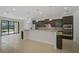 Spacious kitchen with dark cabinets, granite countertops, and a breakfast bar overlooking the backyard at 15608 31St E St, Parrish, FL 34219