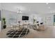 Bright and airy living room with contemporary furnishings, a large television, and stylish decor at 15608 31St E St, Parrish, FL 34219