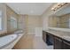 A bright main bathroom features a separate shower and soaking tub at 15608 31St E St, Parrish, FL 34219