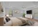 Spacious main bedroom featuring a tray ceiling, hardwood floors, and multiple windows at 15608 31St E St, Parrish, FL 34219