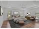 Comfortable main bedroom features neutral paint, wood flooring, and large windows that bring in plenty of natural light at 15608 31St E St, Parrish, FL 34219