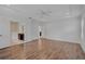 This spacious main bedroom features wood floors, a ceiling fan, and doors to the en suite bathroom at 15608 31St E St, Parrish, FL 34219