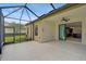A screened-in patio featuring a ceiling fan, tile floors, and sliding glass doors leading to the home's interior at 15608 31St E St, Parrish, FL 34219