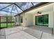 A covered outdoor patio with large glass doors leading to the interior at 15608 31St E St, Parrish, FL 34219