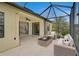 Covered patio with outdoor furniture, a ceiling fan, and a view of tropical landscaping at 15608 31St E St, Parrish, FL 34219