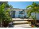 Charming back porch with tropical plants, stylish outdoor furniture, and a cozy atmosphere for relaxing or entertaining at 1814 6Th W Ave, Bradenton, FL 34205