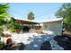 Backyard with a storage shed and a covered parking area behind a wooden fence at 1814 6Th W Ave, Bradenton, FL 34205