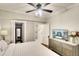This bedroom features a ceiling fan, ensuite bathroom with a shower, and a large walk-in closet at 1814 6Th W Ave, Bradenton, FL 34205